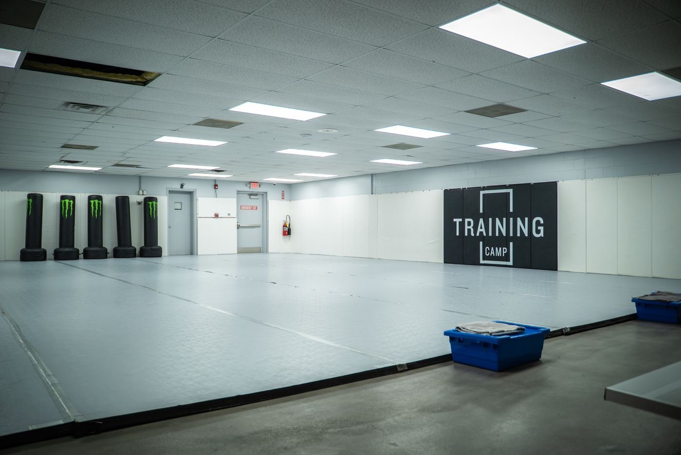 Training Camp mat room with standing bags