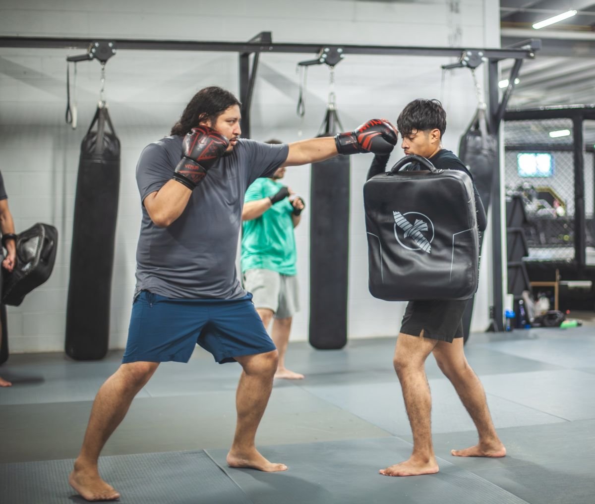Pad work on the shield in Muay Thai class