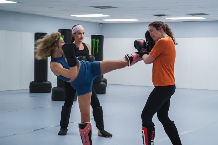 Women's Muay Thai class on the pads